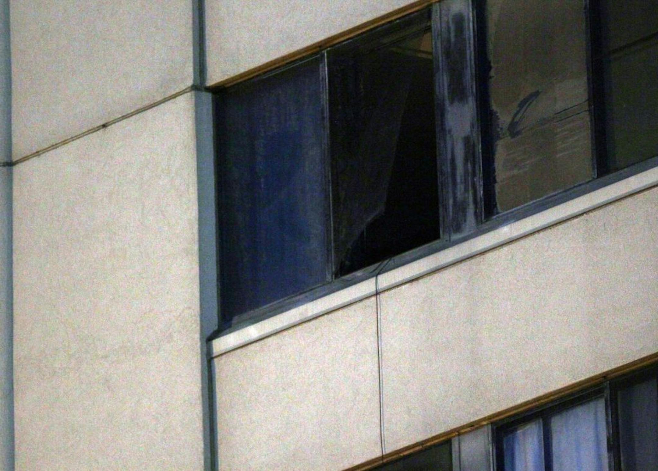 Late Tuesday, a piece of torn window screen hung from the apartment window at Skyline Towers apartment building in St. Paul.