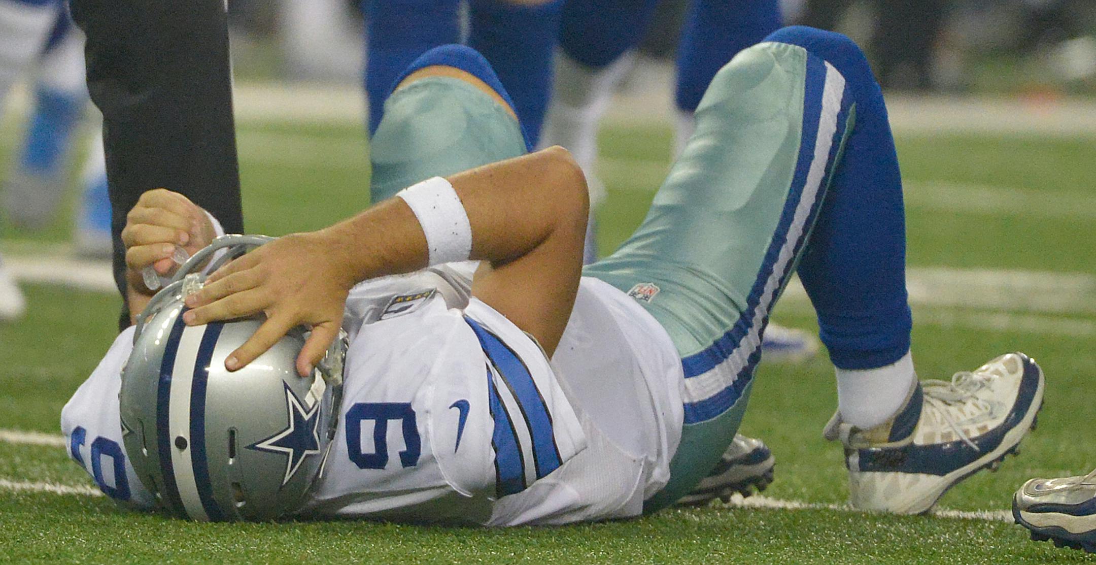 Dallas Cowboys quarterback Tony Romo (9) is in pain after a hit by Washington Redskins inside linebacker Keenan Robinson (52) during third quarter on Monday, Oct. 27, 2014, at AT&T Stadium in Arlington, Texas. (Max Faulkner/Fort Worth Star-Telegram/MCT) ORG XMIT: 1159250