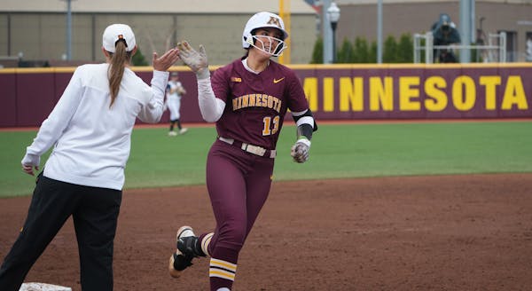 Minnesota catcher Taylor Krapf (13) rounds third after hitting her second homerun against Michigan in the second inning at Jane Sage Cowles Stadium in