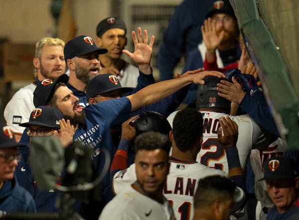 Minnesota Twins first baseman Miguel Sano (22) was congratulated in the dugout after his third home run of the game.