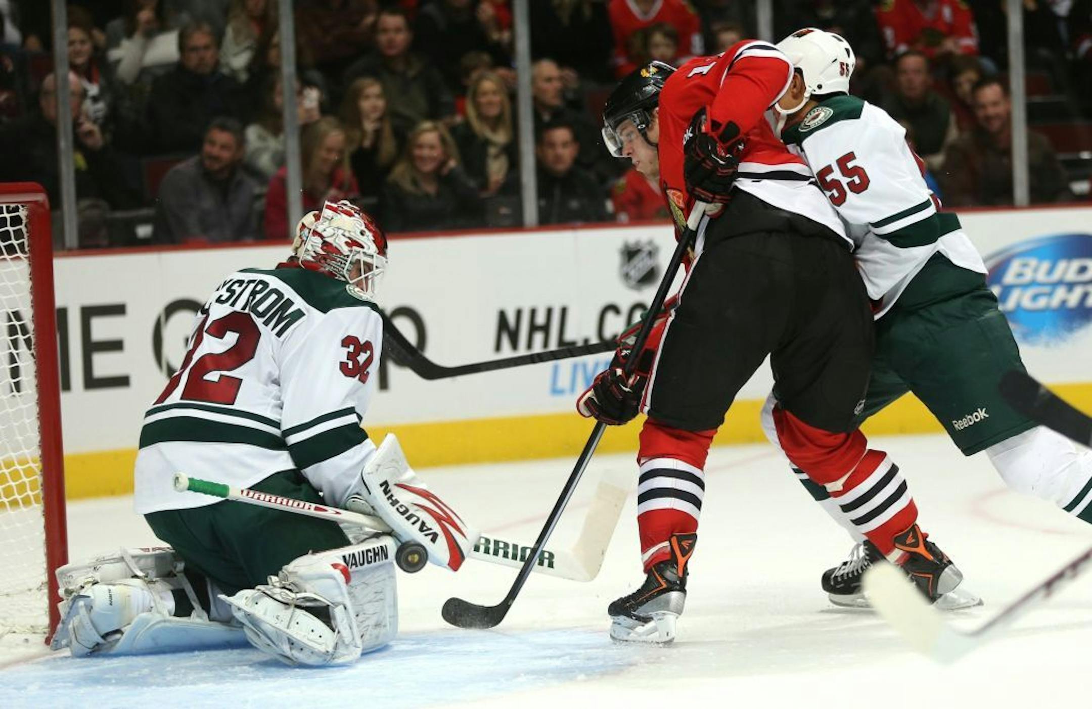 Minnesota Wild goalie Niklas Backstrom (32) stops Chicago Blackhawks player Jeremy Morin (11) from scoring in the first period at the United Center in Chicago, Illinois, on Saturday, October 26, 2013.