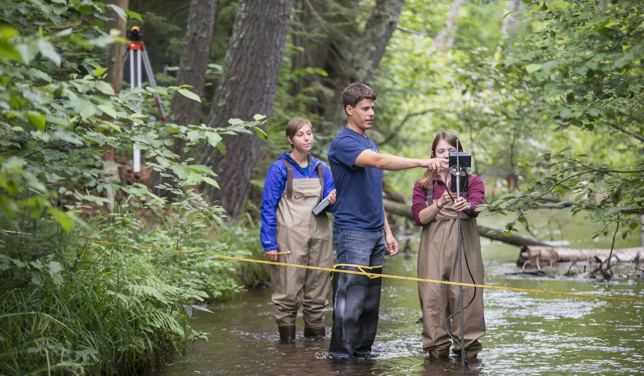 Photo provided by Northland College. Northland Collegeís Sigurd Olson Environmental Institute Watershed Program Coordinator Matt Hudson assists Elizabeth Alexson, an Environmental Geosciences and a Water Science who graduated in May and is now attending graduate school in the University of Minnesotaís Water Resources Science program, in collecting data to understand and improve the regionís water resources while junior Kim Oldenborg, a biology and natural resources student, looks