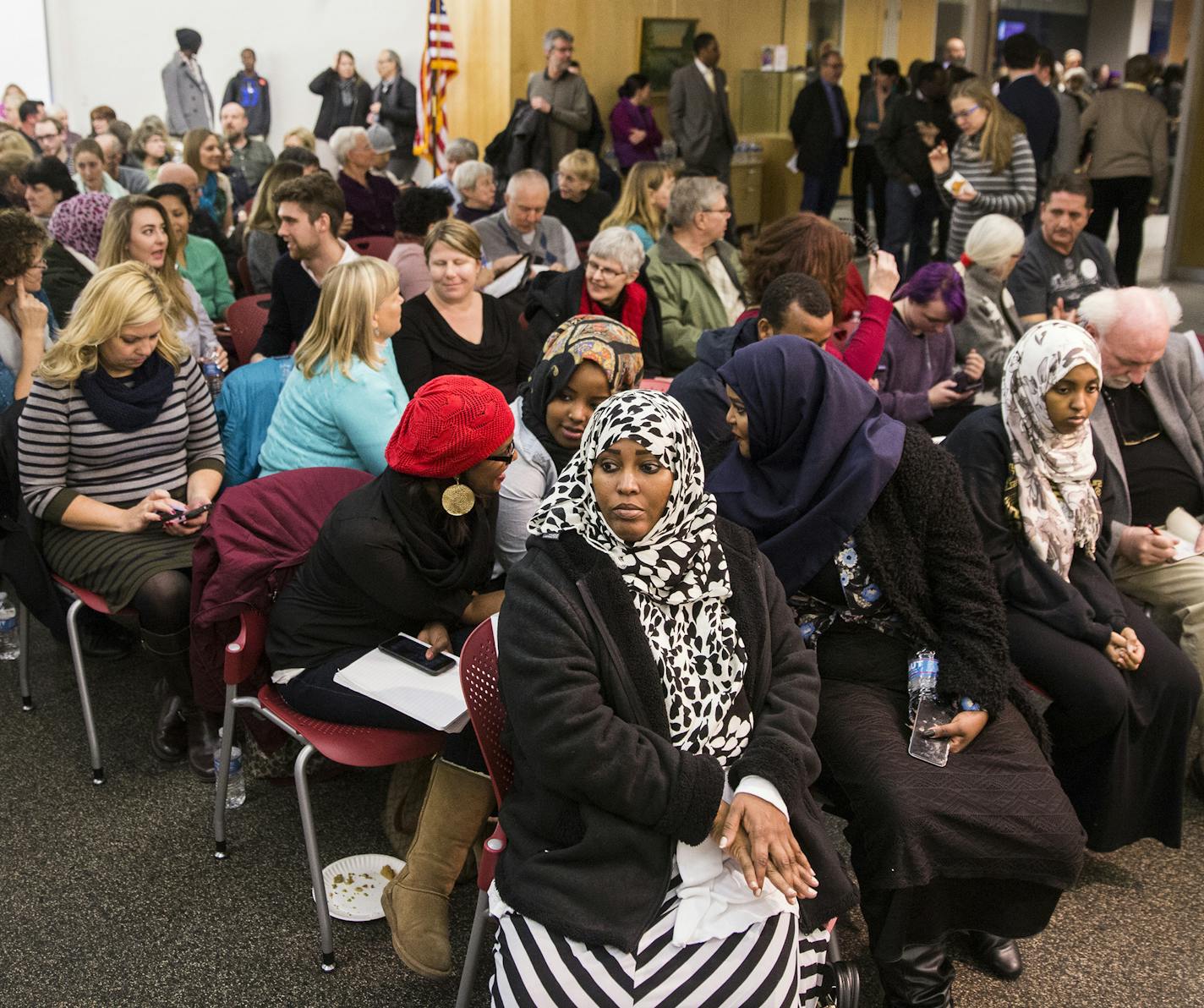 Lul Hersi, center front, a Somali-American and community advocate in St. Cloud, waits in the audience to sit on the panel of a forum discussion entitled "Muslims in Minnesota: A community conversation" held by Minnesota Public Radio at St. Cloud Library on Thursday, January 28, 2016. ] (Leila Navidi/Star Tribune) leila.navidi@startribune.com