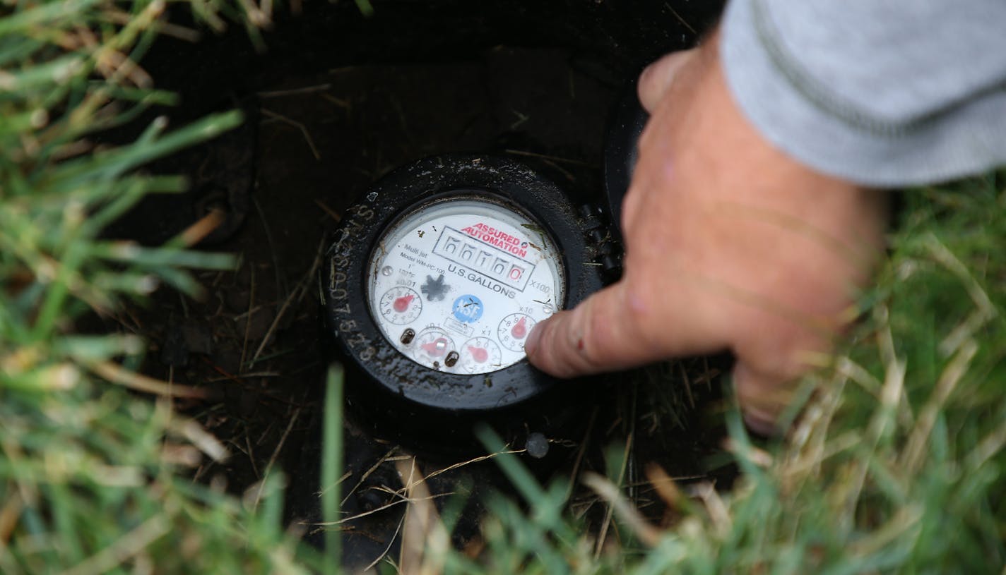 Sam Bauer, who studies lawns and grasses checked a water meter while working in the experimental growing fields at the UMN St. Paul campus Monday October 2,2017 in St. Paul, MN.