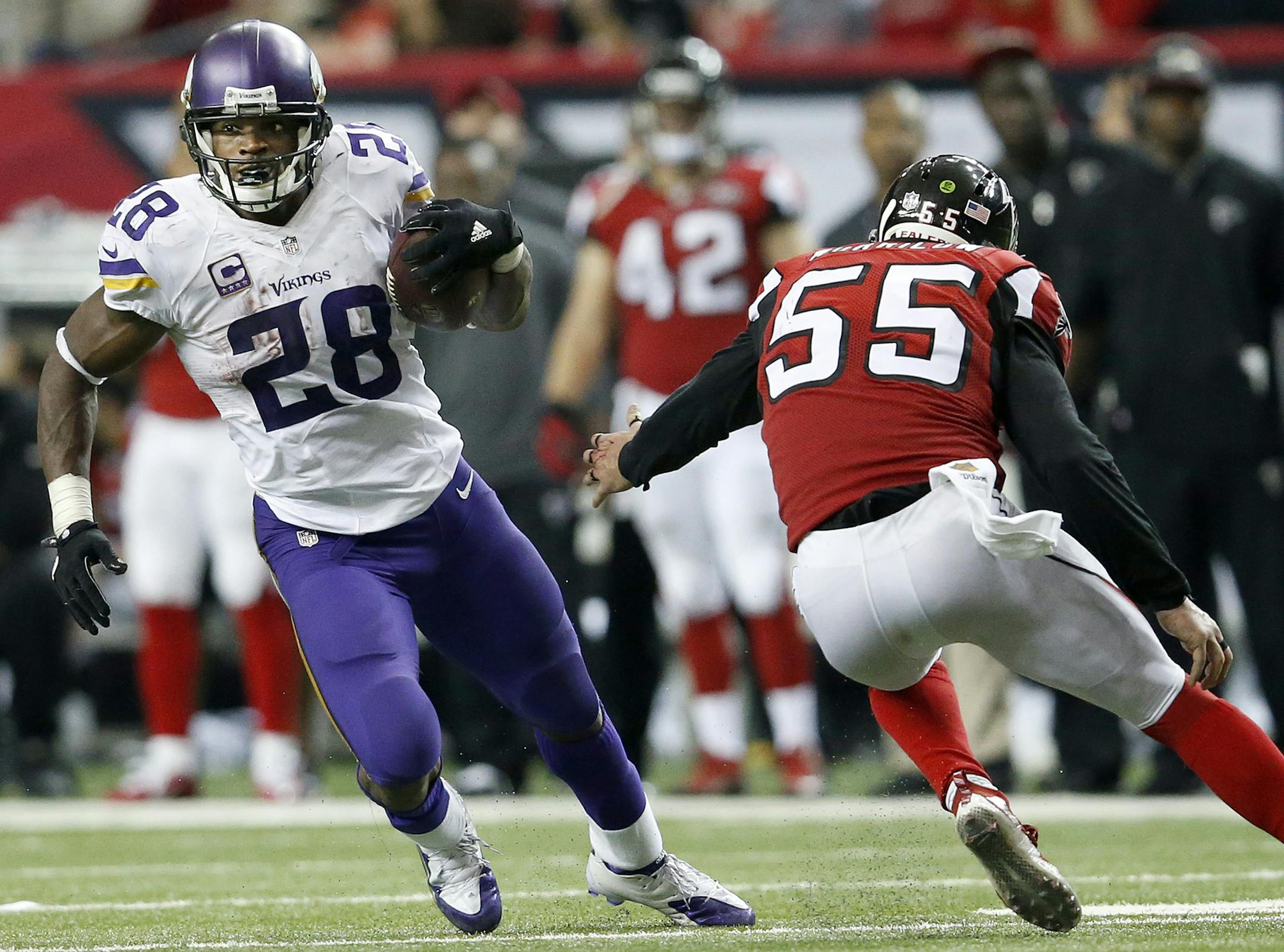 Running back Adrian Peterson, left, is the leading rusher in the NFL and could carry the Vikings to the NFC North title.