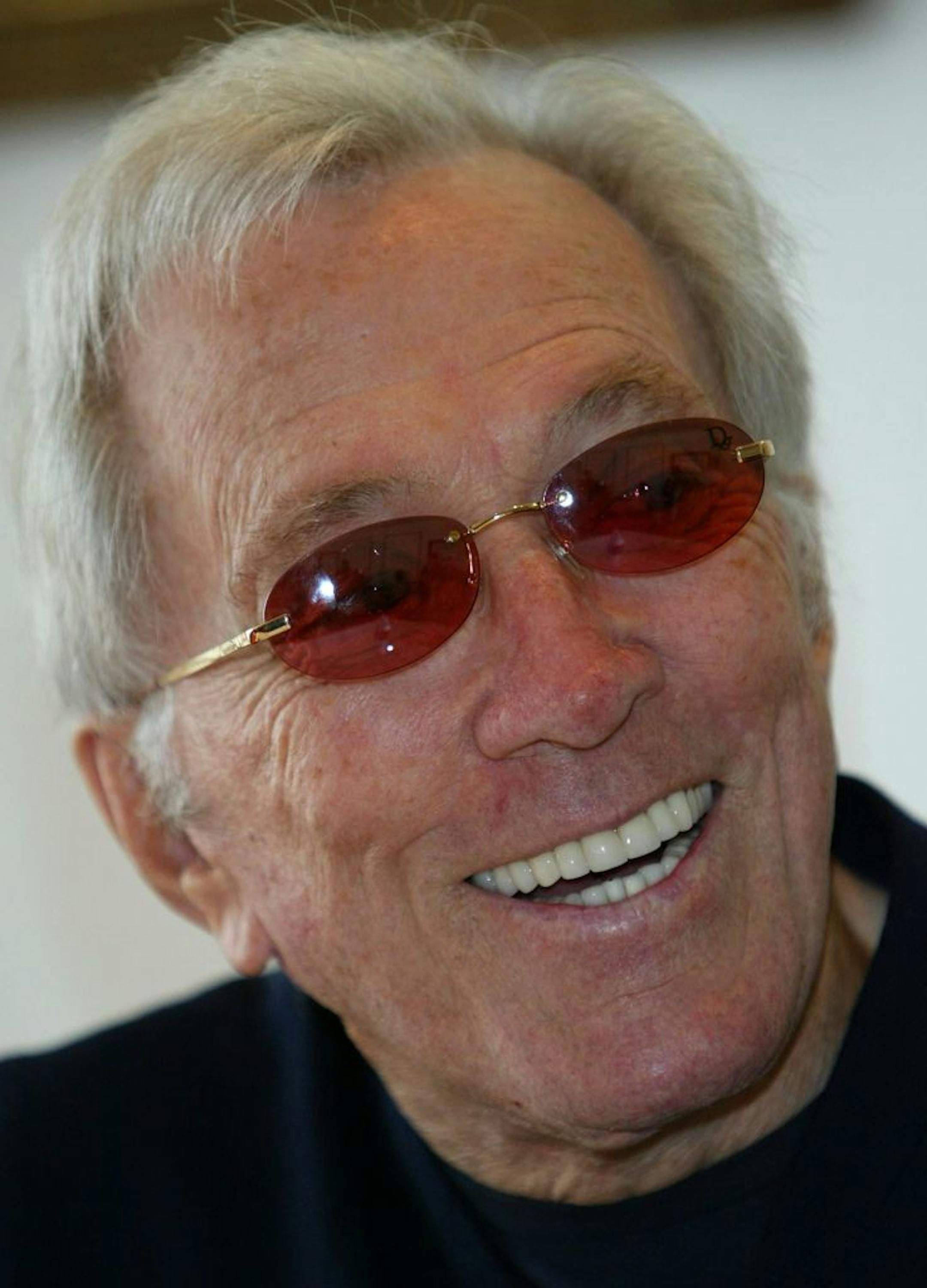 FILE - In this July 25, 2004 file photo, U.S. singer Andy Williams smiles as he speaks to reporters during his news conference at a Tokyo hotel. Emmy-winning TV host and "Moon River" crooner Williams died Tuesday night, Sept, 25, 2012 at his home in Branson, Mo., following a year-long battle with bladder cancer. He was 84.