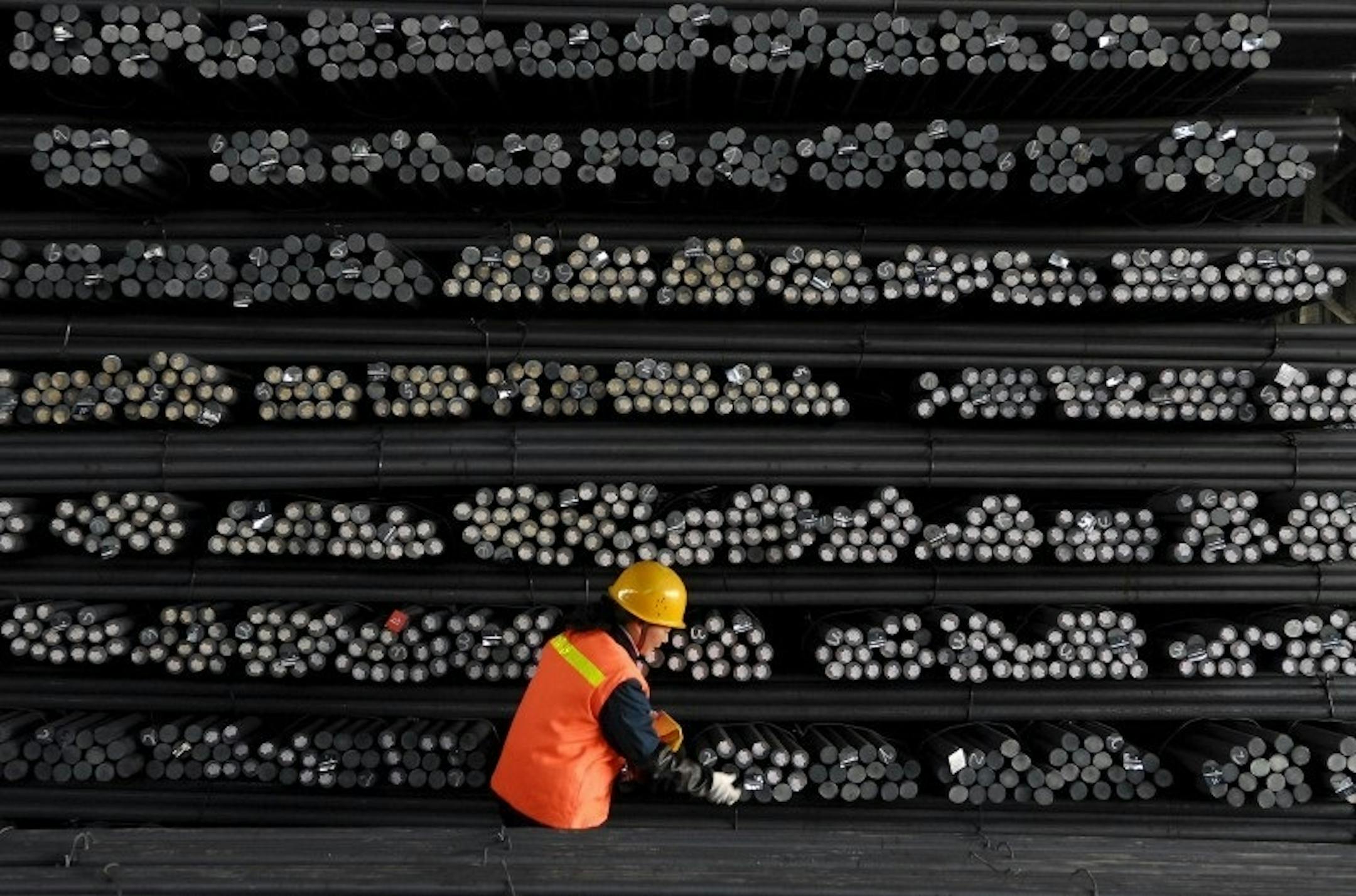 A labourer marks steel bars at a steel and iron factory in Huai'an, Jiangsu province, China, in this February 18, 2008 file photo. REUTERS/Patty Chen/Files