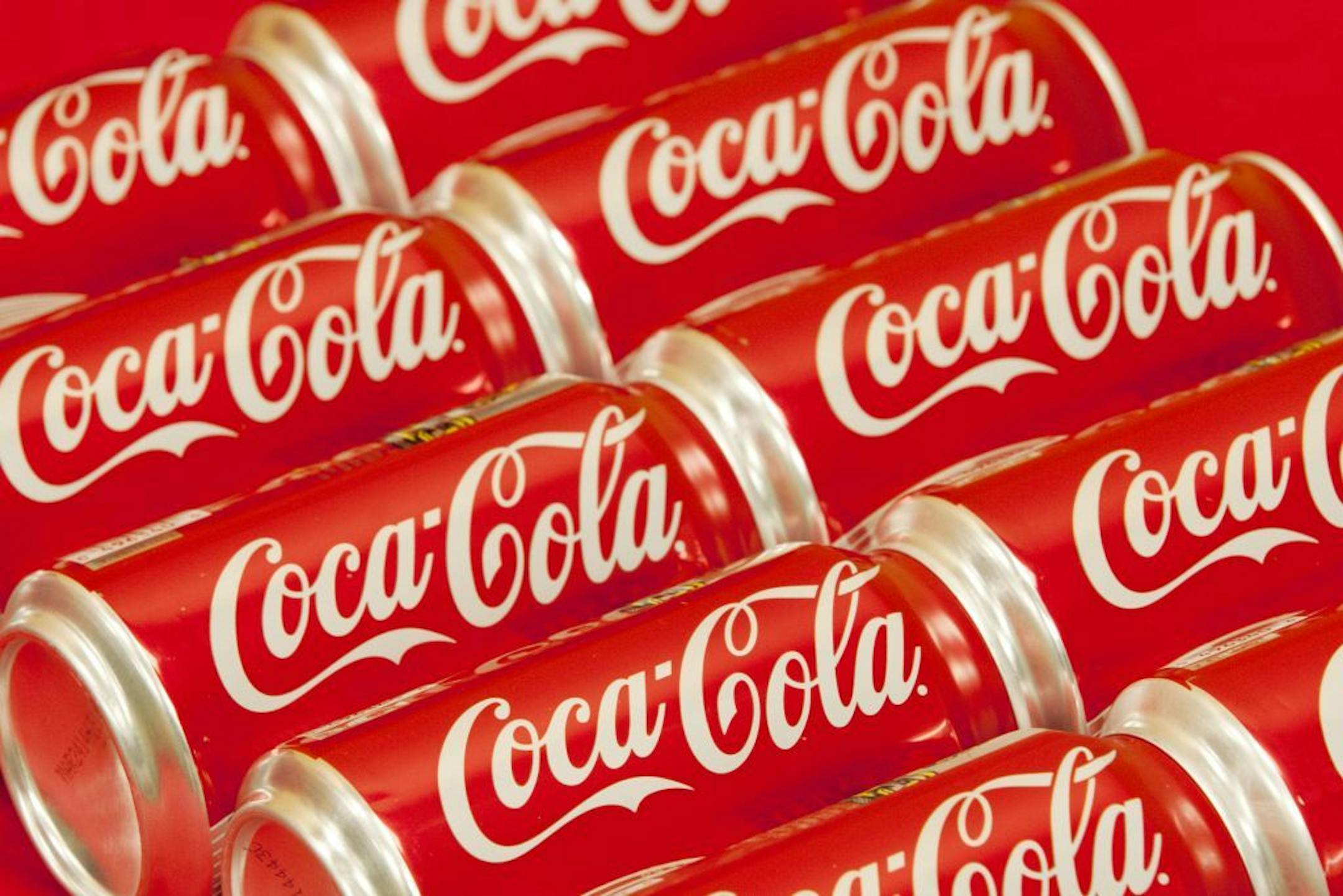 In this Monday, July 15, 2013 photo, bottle tops of Coca-Cola 8 oz. bottles are shown in Doral, Fla. The Coca-Cola Co. reports quarterly financial results before the market opens on Tuesday, July 16, 2013.