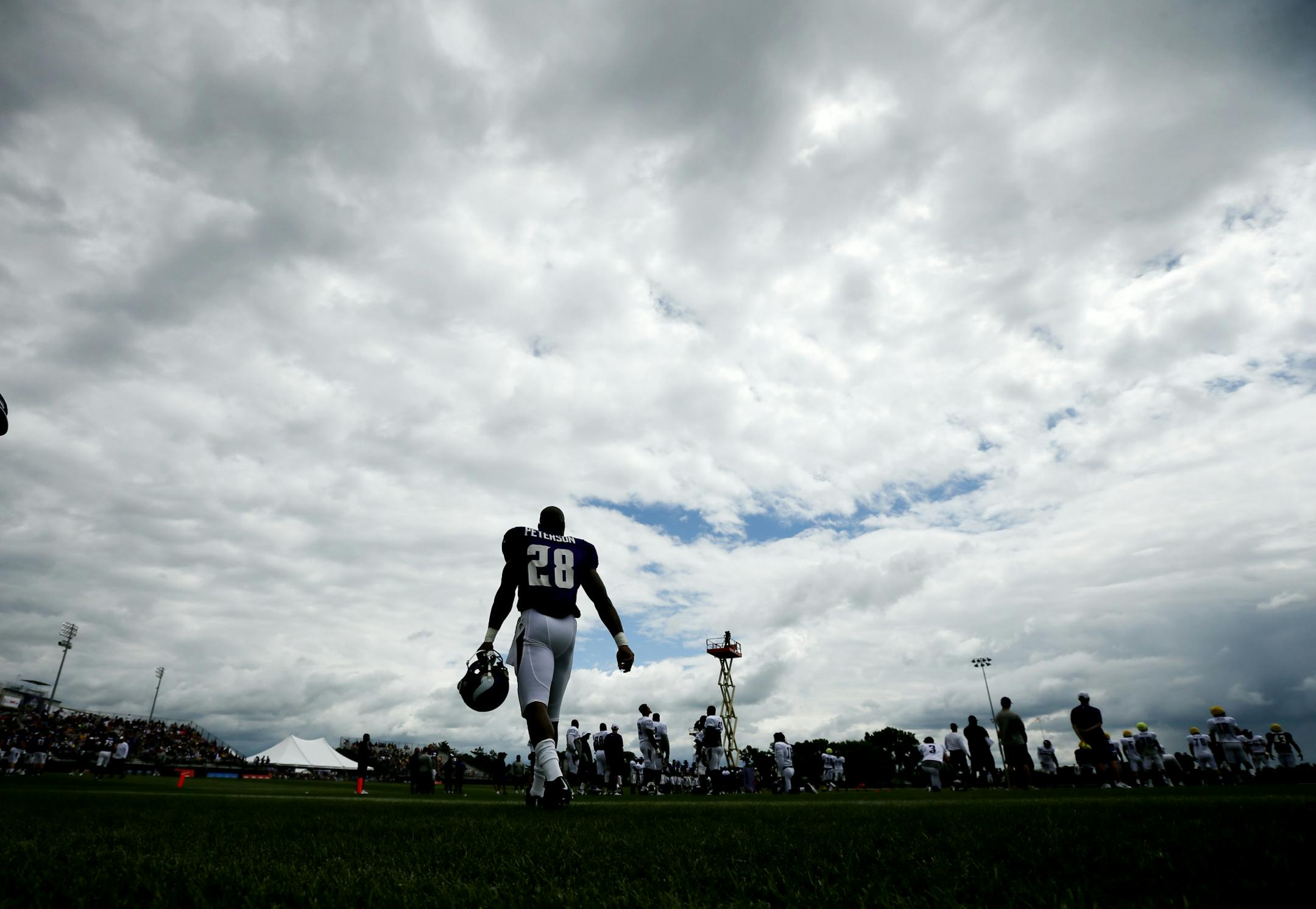 Adrian Peterson walked on the field on a rainy day during NFL camp at Minnesota State ,Mankato Sunday July 27, 2014 in Mankato, MN .