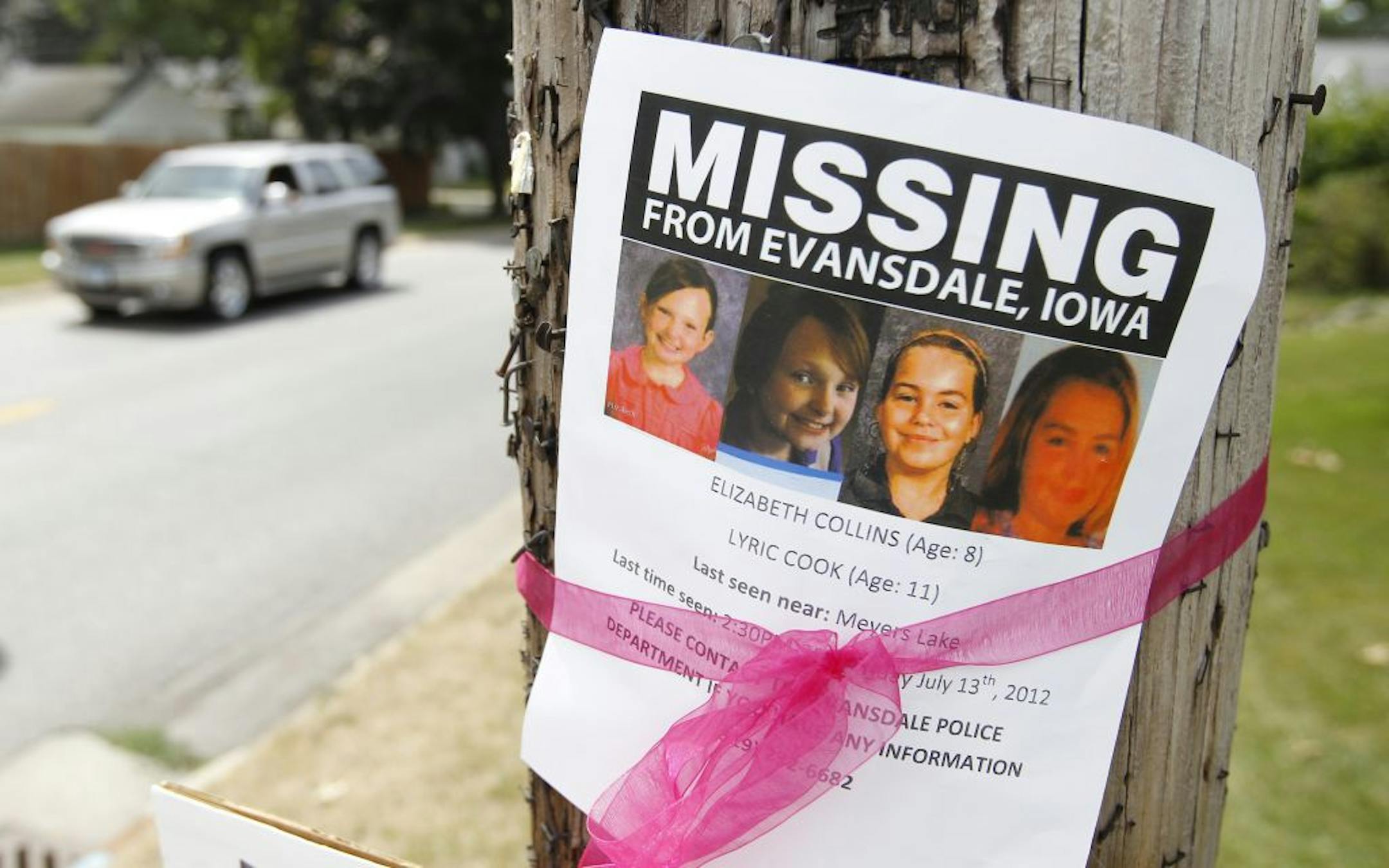 A sign is posted on Fletcher Avenue for the missing cousins Lyric Cook-Morrissey, 10, and Elizabeth Collins, 8, Thursday, July 19, 2012, in Waterloo, Iowa.