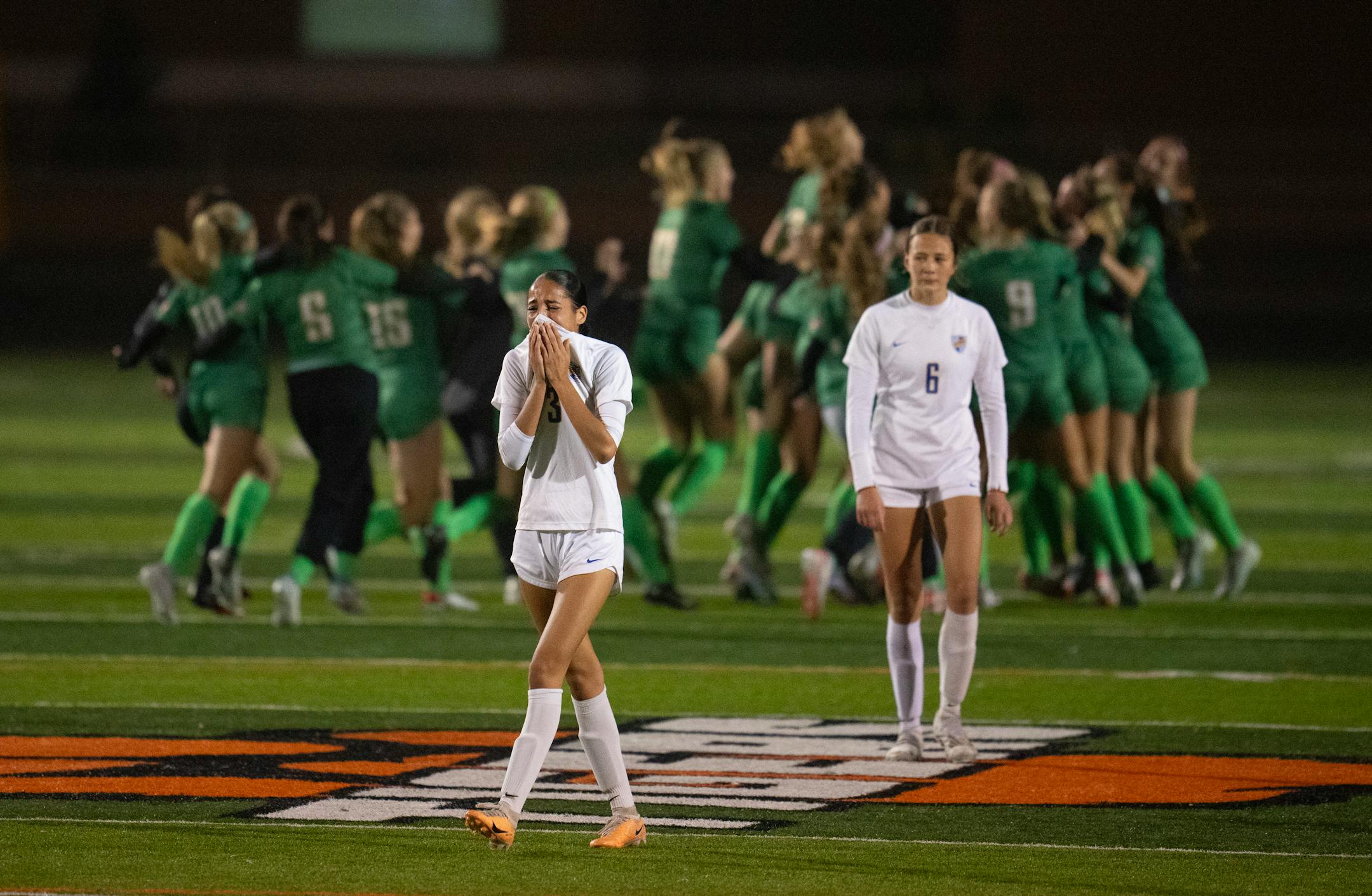 St. Michael-Albertville's Tailyn Radloff (3) and Emma Kvant (6) walked towards their teammates as Edina celebrated their win.