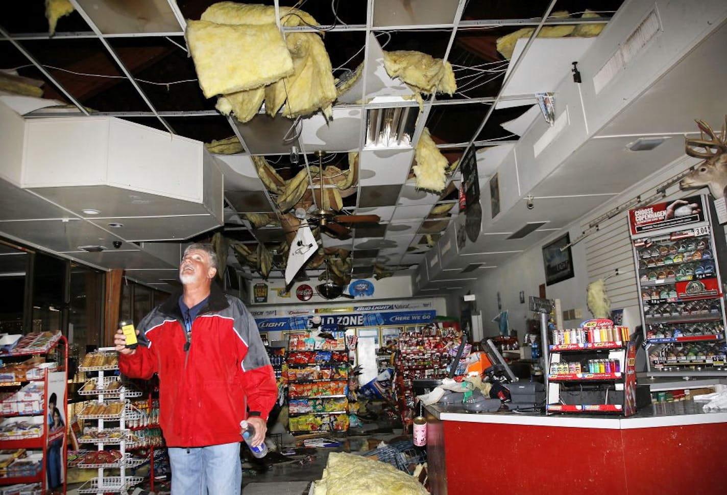 Ron Ulloa looks over his damaged business at I-40 on May 31, 2013 in El Reno, Okla. Emergency officials set out Saturday morning to see how much damage a violent burst of thunderstorms and tornadoes caused as it swept across the Midwest overnight, killing at least five and injuring dozens. The storm toppled cars and left commuters trapped on an interstate highway as it bore down during Friday's evening rush hour near Oklahoma City. The National Weather Service reported "several" tornadoes rolled