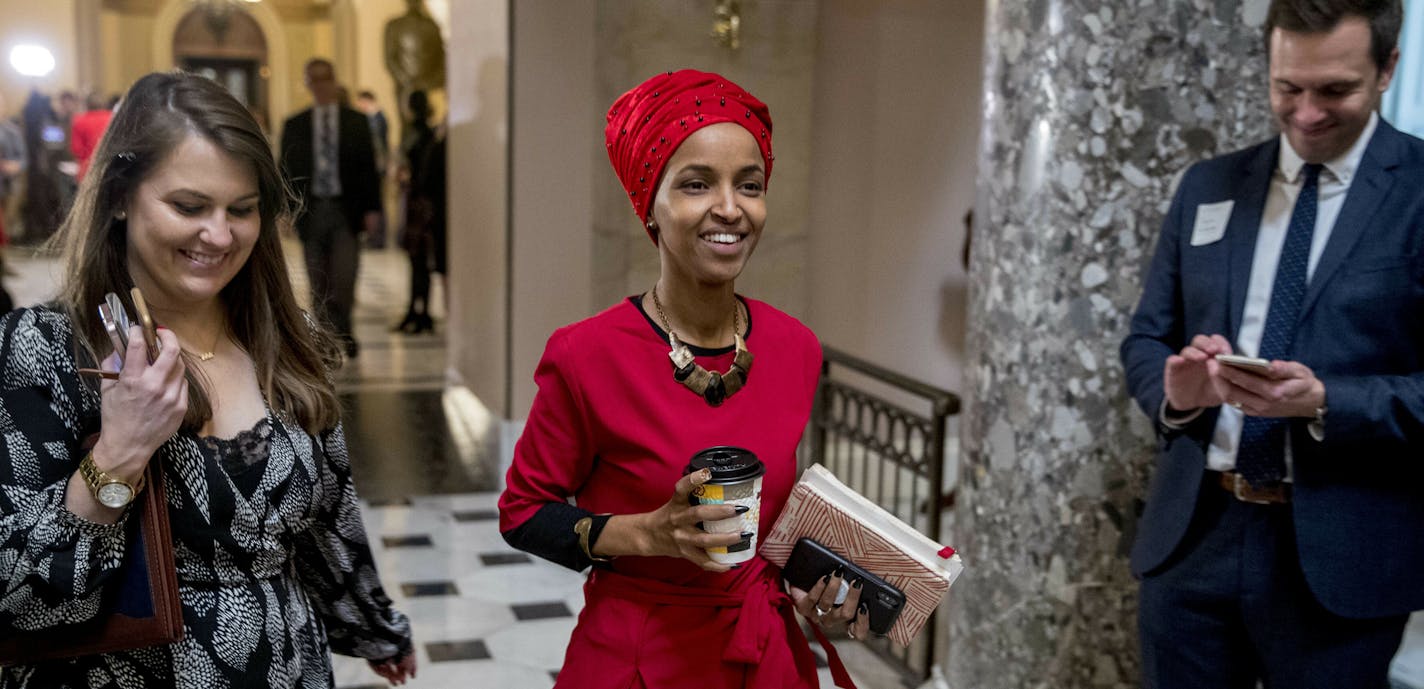 Rep. Ilhan Omar, D-Minn., center, walks through the halls of the Capitol Building in Washington, Wednesday, Jan. 16, 2019. (AP Photo/Andrew Harnik)