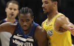 Minnesota Timberwolves forward Andrew Wiggins (22) drove against the defense of Los Angeles Lakers guard Josh Hart (3) in the second half. ] JEFF WHEE