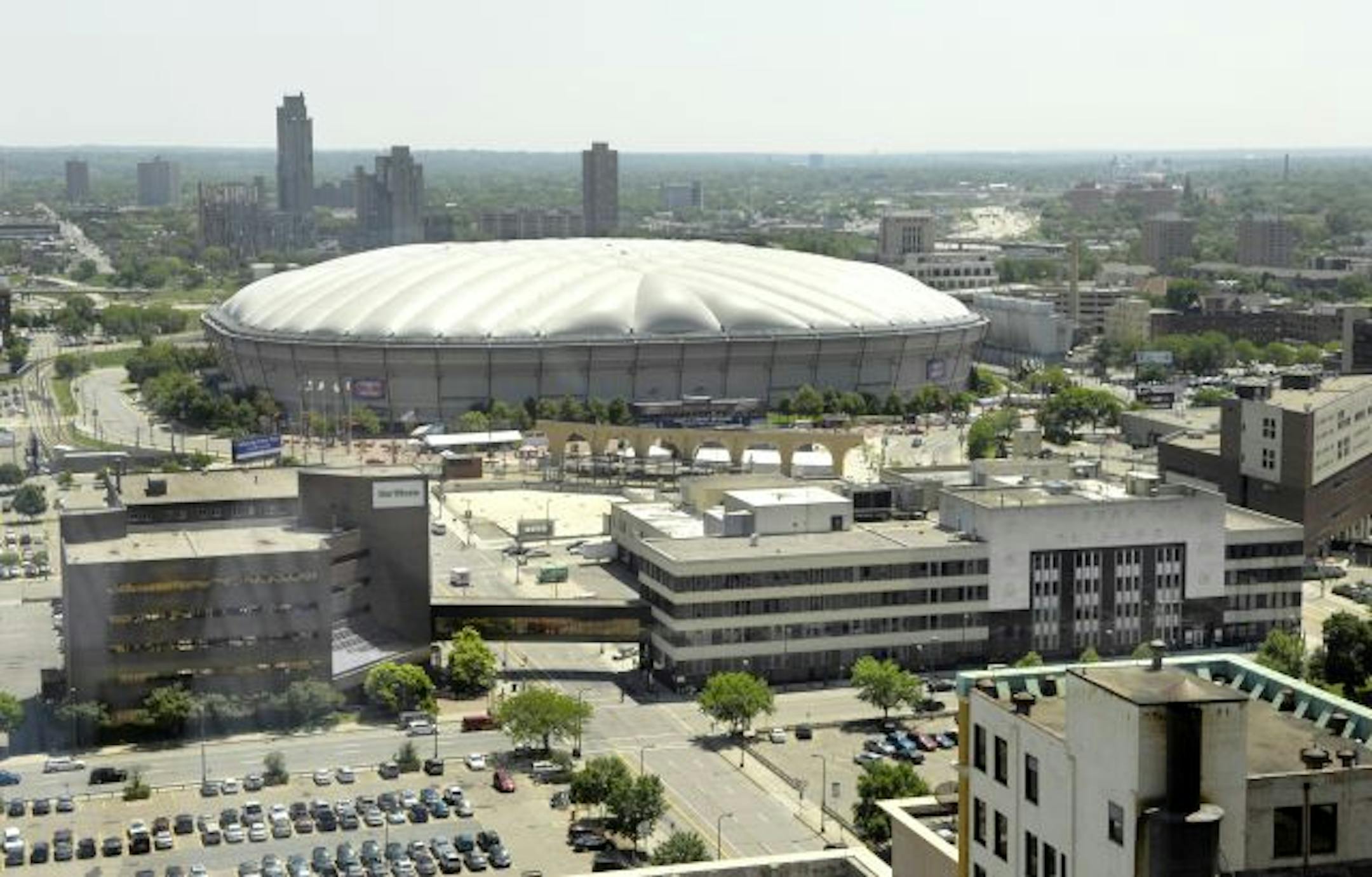 The Star Tribune Buildings on Portland Avenue and surrounding real estate are for sale. in the background is the Humphrey Metrodome. Star Tribune owners Avista. parking lots