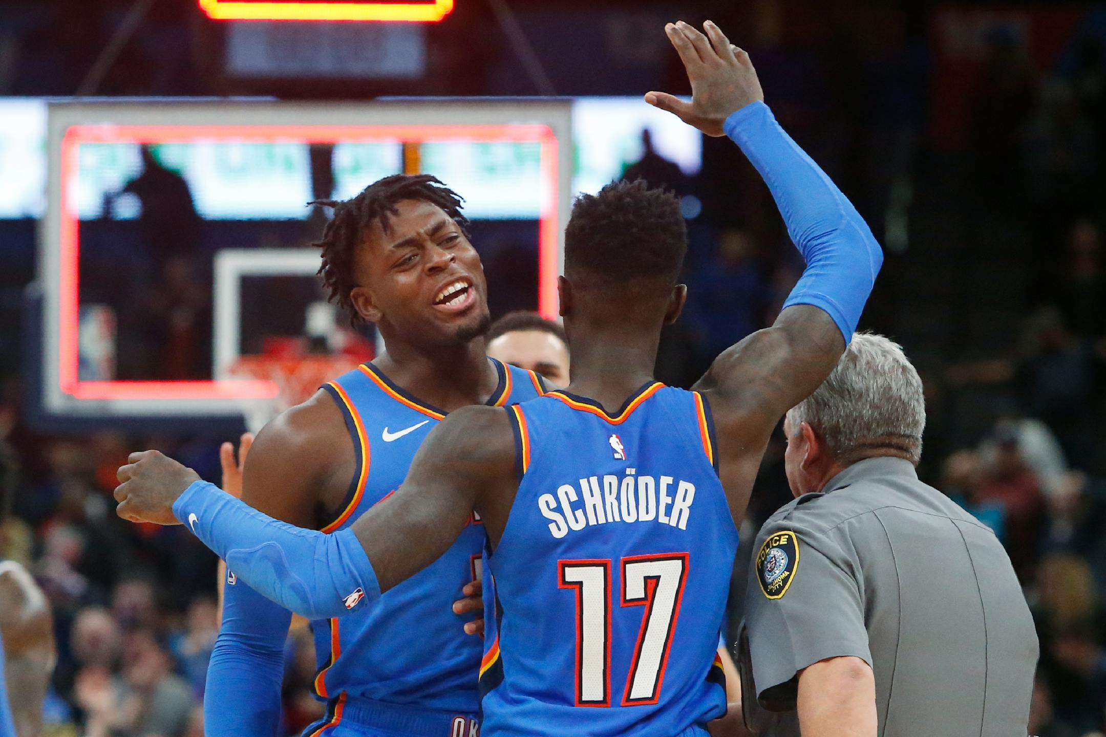 Oklahoma City Thunder guard Dennis Schroder (17) celebrates with Luguentz Dort, left, after Schroder hit a basket to force overtime