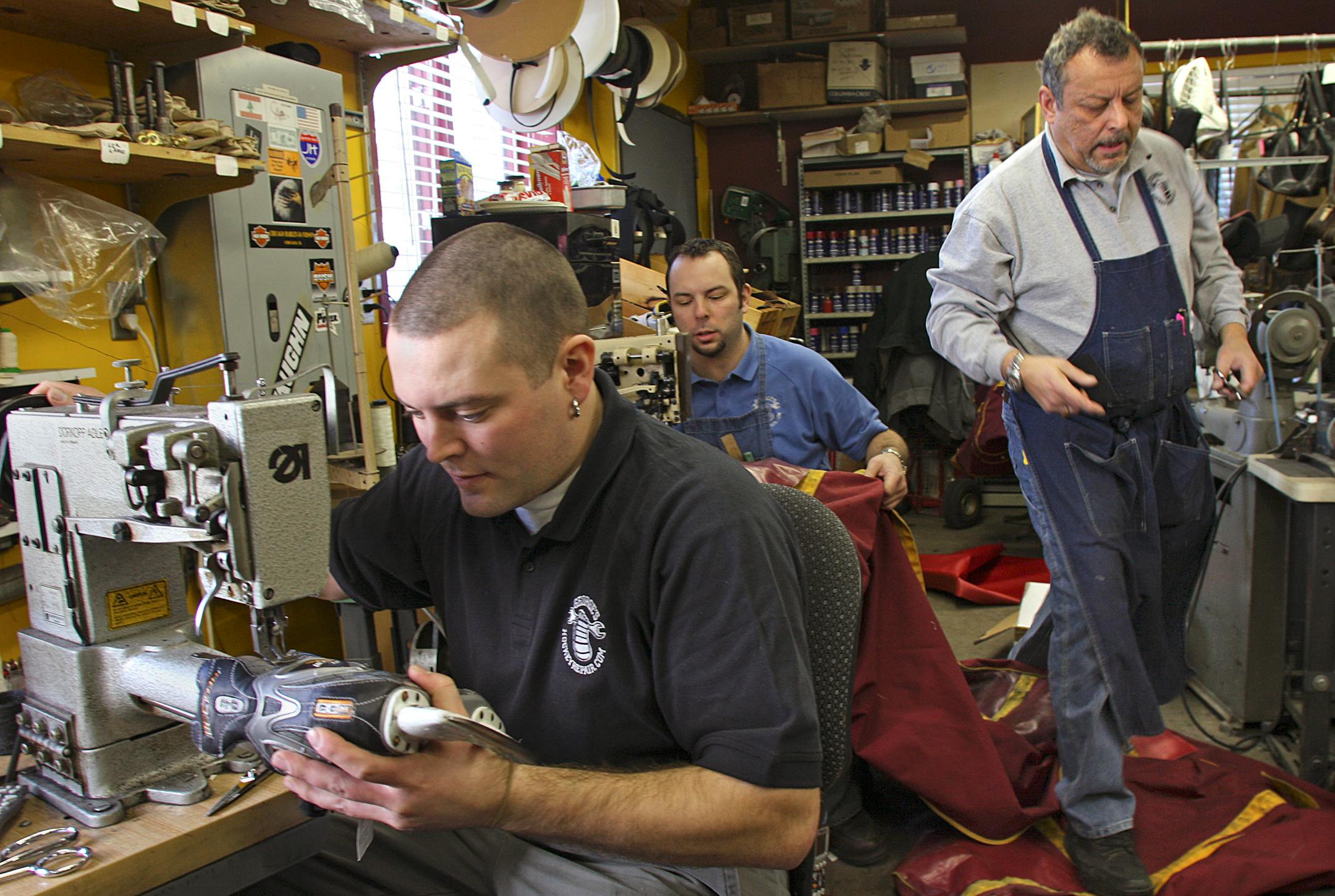 From the left, Dan George repaired a hockey skate and Brian George repaired Gophers hockey travel bag as Jerry George, their dad, worked on goalie leg pads at George's Shoe and Skate Repair in St. Paul. The shop specializes in repairing hockey equipment but offers a wide range of repair services.