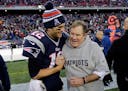New England Patriots quarterback Tom Brady, left, celebrates with head coach Bill Belichick in 2014.