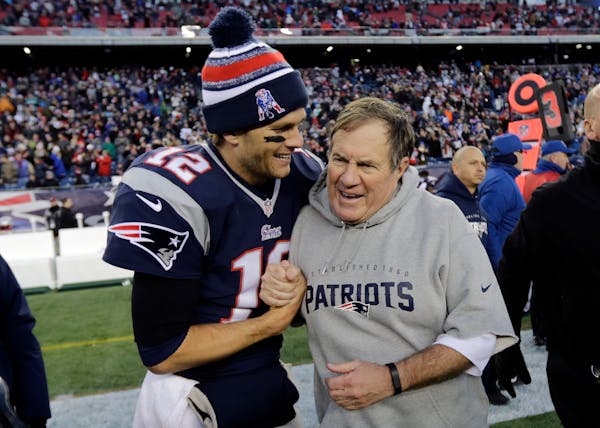 New England Patriots quarterback Tom Brady, left, celebrates with head coach Bill Belichick in 2014.