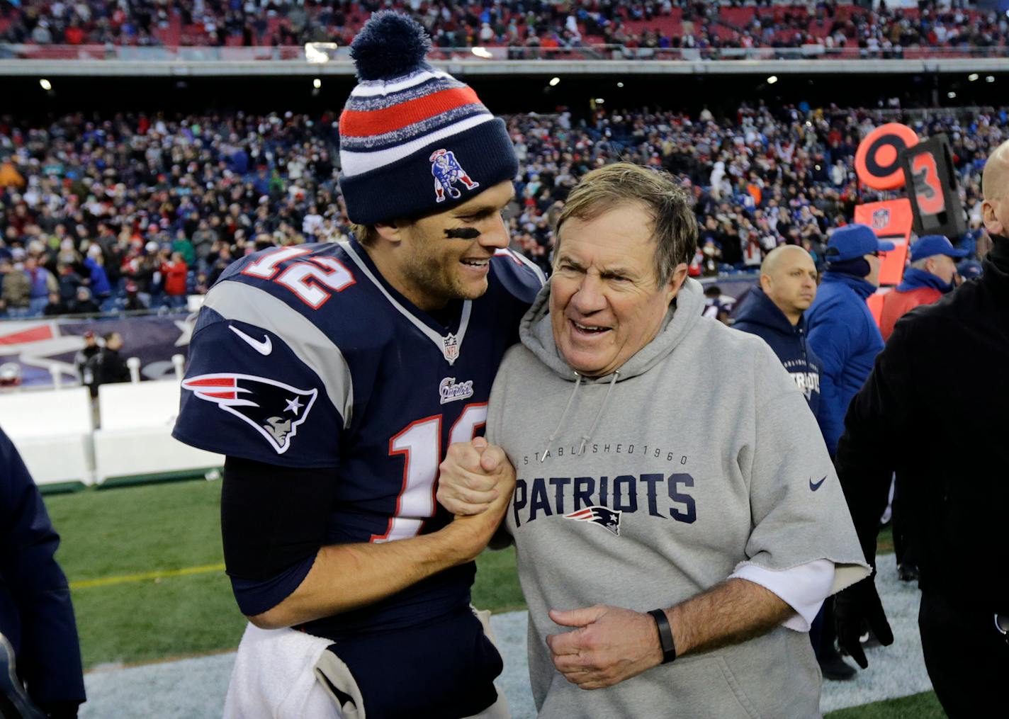 New England Patriots quarterback Tom Brady, left, celebrates with head coach Bill Belichick in 2014.