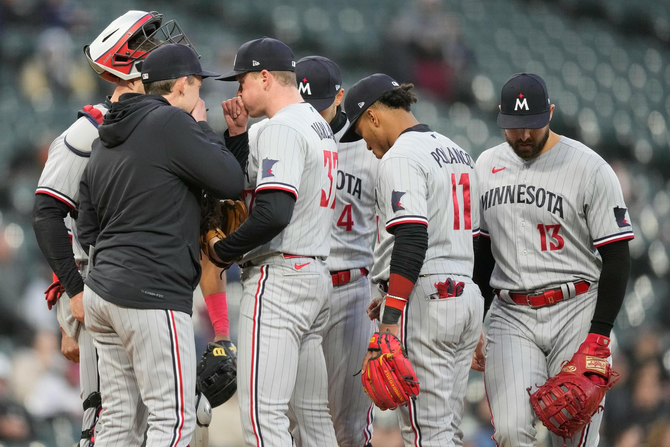 Minnesota Twins pitching coach Pete Maki, left, talks to starting pitcher Louie Varland (37) during the fourth inning of a baseball game against the Chicago White Sox on Wednesday, May 3, 2023, in Chicago. (AP Photo/Charles Rex Arbogast)