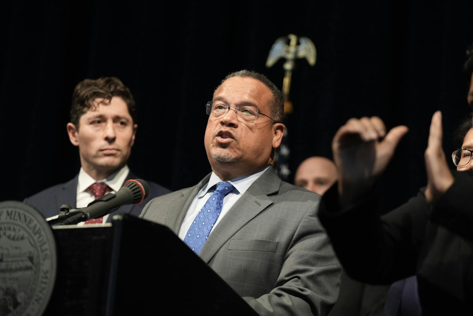 Minnesota Attorney General Keith Ellison, along with Minneapolis Mayor Jacob Frey, announces a lawsuit against the Trump administration for its role in the deployment of ICE agents to the Twin Cities, during a news conference at Minneapolis City Hall on Monday, Jan. 12.