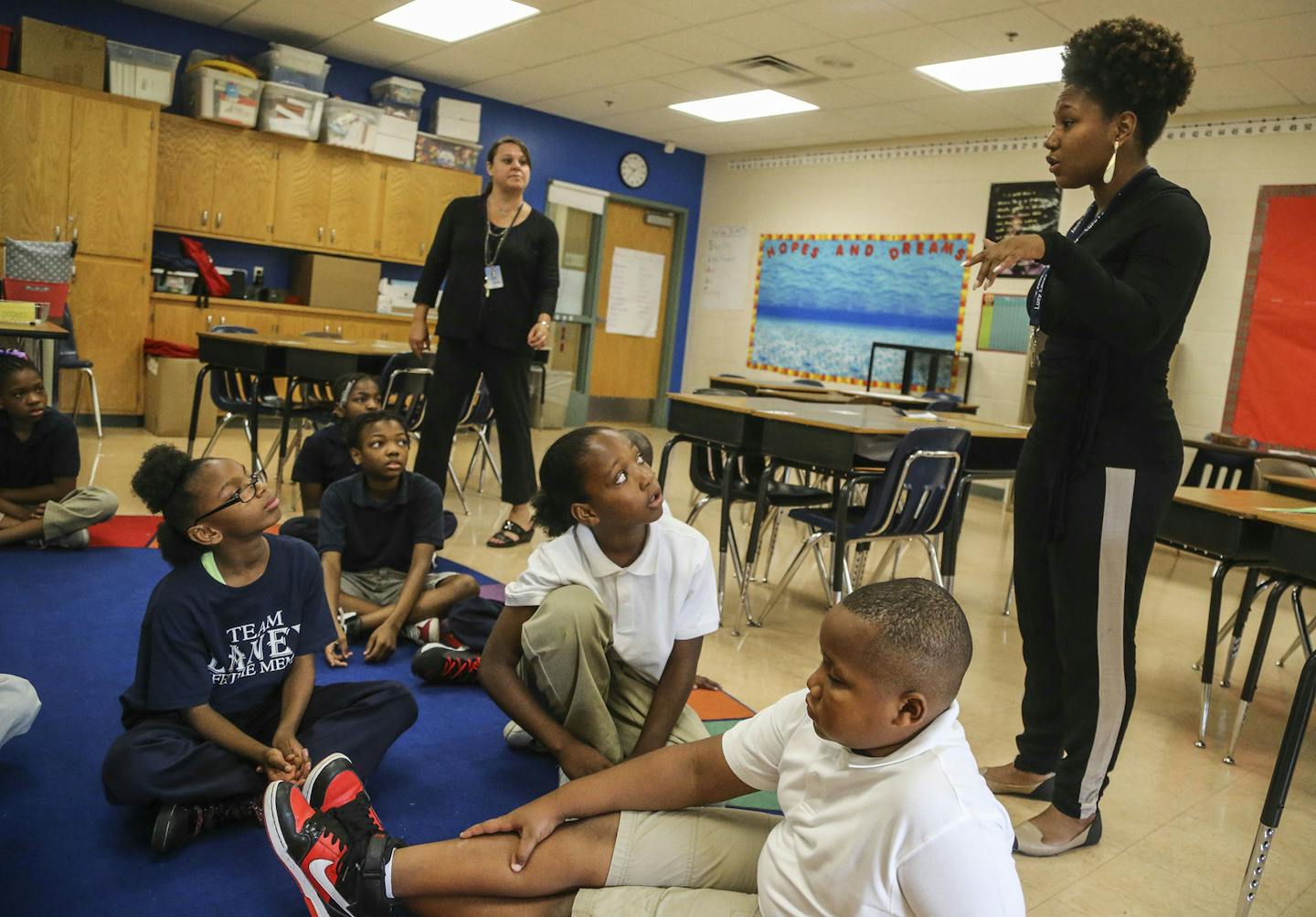 Fifth graders at Lucy Laney Community School have had a boost in math test scores from having two teachers and were seen Thursday Aug. 28, 2014, in Minneapolis MN. Here, fifth grader teachers Brittney Bentley, front, and Nicole Plowman, rear, prepare their students for a multiplication exercise using the game yahtzee. ] (DAVID JOLES/STARTRIBUNE)djoles@startribune.com No seventh grader at Lucy Laney communtiy school met state reading standards last year. According to MCA scores, seventh grade rea