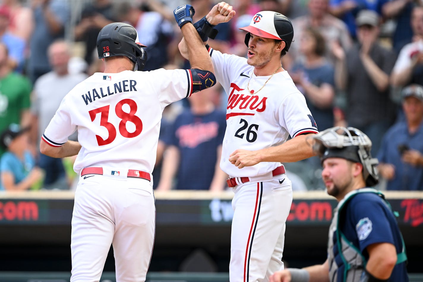 Minnesota Twins right fielder Matt Wallner (38) celebrates with right fielder Max Kepler (26) after the two scored off a home run hit by Wallner in the bottom of the first inning against the Seattle Mariners Tuesday, July 25, 2023 at Target Field in Minneapolis, Minn.. ] AARON LAVINSKY • aaron.lavinsky@startribune.com