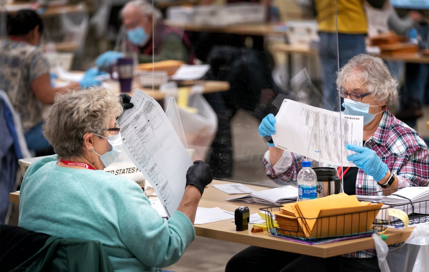 Ramsey County election judges Nancy Matthews and Kathy Lair checked ballots as they removed them from ballot envelopes.