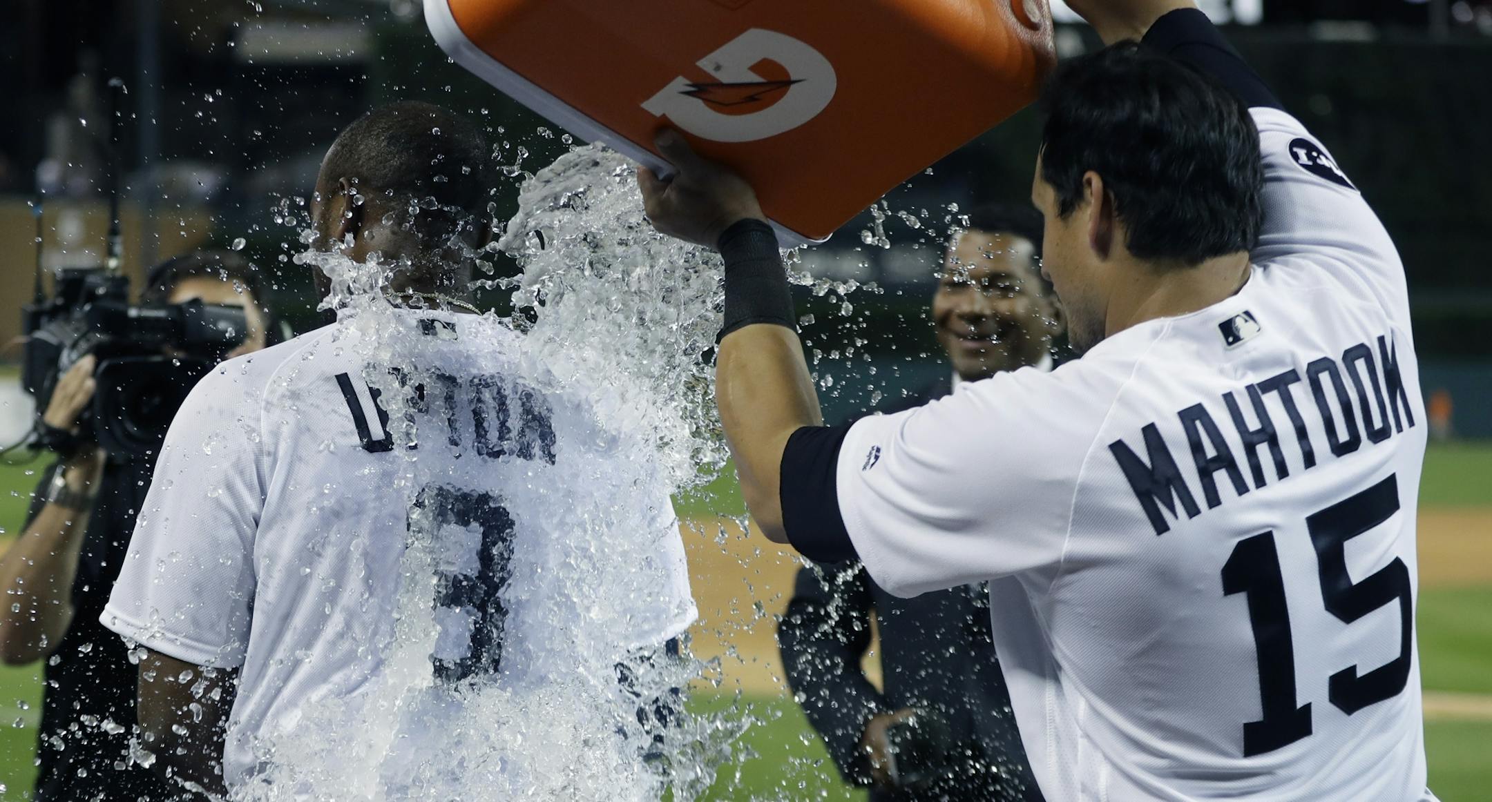 Detroit Tigers' Justin Upton is doused by teammate Mikie Mahtook after hitting a two-run walk-off home run during the ninth inning of a baseball game against the Minnesota Twins, Saturday, Aug. 12, 2017, in Detroit. (AP Photo/Carlos Osorio)