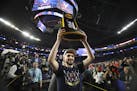 Virginia's Ty Jerome hoisted the championship trophy aloft Monday as he walked off the U.S. Bank Stadium court. The Cavaliers showed that not just the