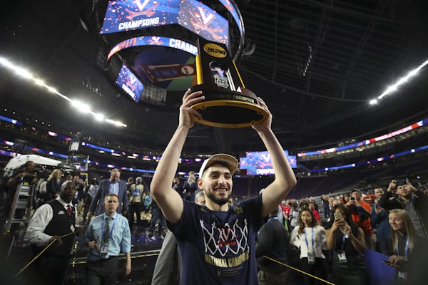 Virginia's Ty Jerome hoisted the championship trophy aloft Monday as he walked off the U.S. Bank Stadium court. The Cavaliers showed that not just the