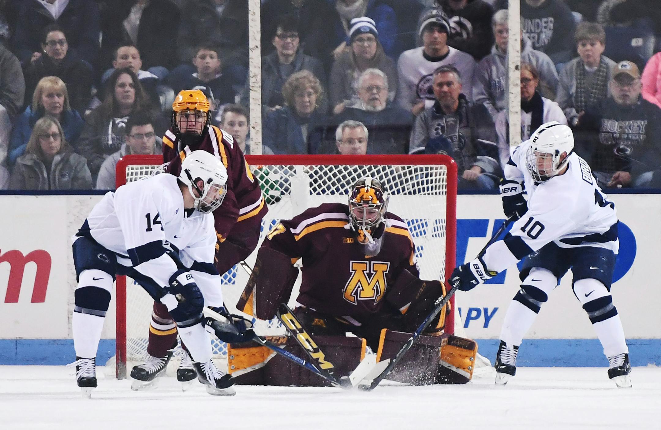 Gophers goaltender Eric Schierhorn stops a shot by Penn State's Brandon Biro (10) as Penn State's Nate Sucese waits for a rebound.