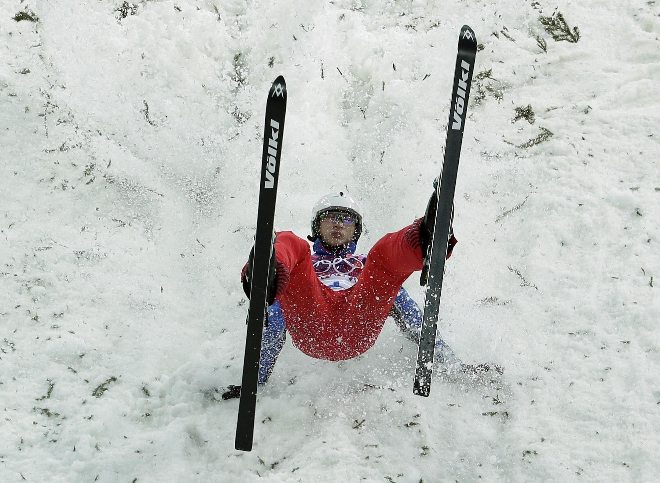 China's Liu Zhongqing crashes upon landing during men's freestyle skiing aerials qualifying at the Rosa Khutor Extreme Park, at the 2014 Winter Olympics, Monday, Feb. 17, 2014, in Krasnaya Polyana, Russia.