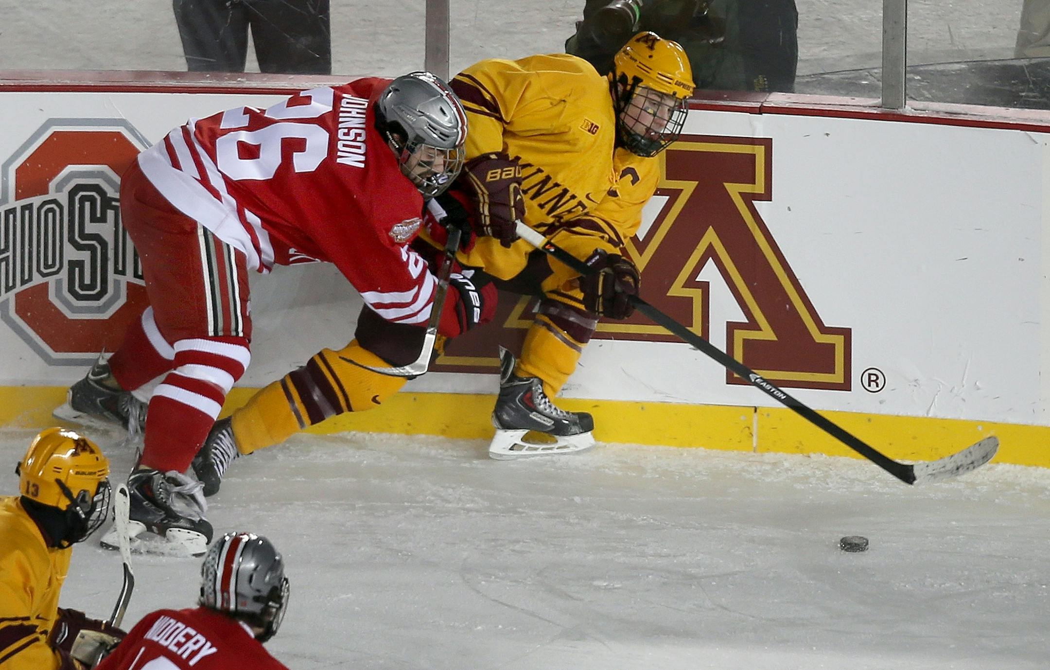 Travis Boyd and Ohio State's Matt Johnson battled for possession during the second period at TCF Bank Stadium, Friday, January 17, 2014 in Minneapolis