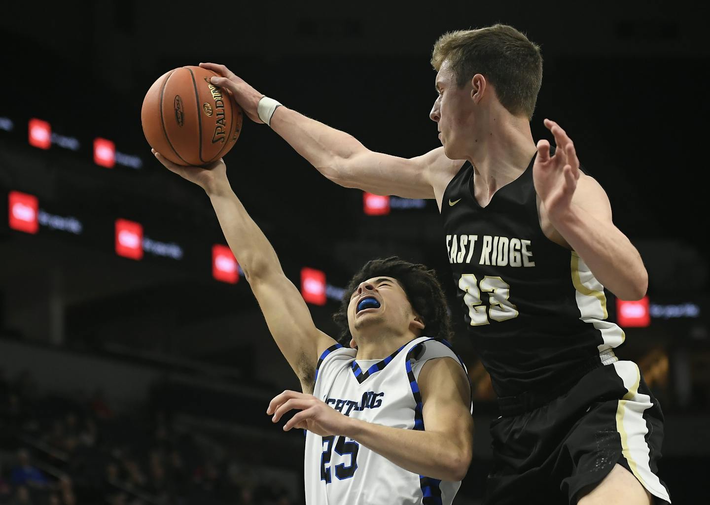 East Ridge forward Ben Carlson (23) blocked a layup attempt by Eastview guard Caden Scales (25) in the first half. ] Aaron Lavinsky &#xa5; aaron.lavinsky@startribune.com East Ridge played Eastview in a Class 4A state tournament quarterfinal game on Wednesday, March 20, 2019 at Target Center in Minneapolis, Minn.