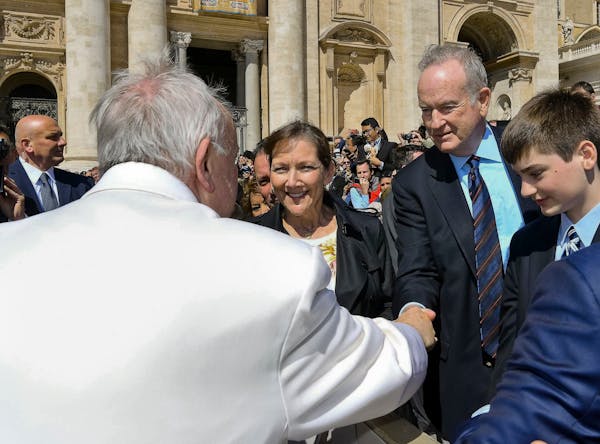 Pope Francis shakes hands with TV host Bill O'Reilly, second from right, during his weekly general audience, at the Vatican, Wednesday, April 19, 2017