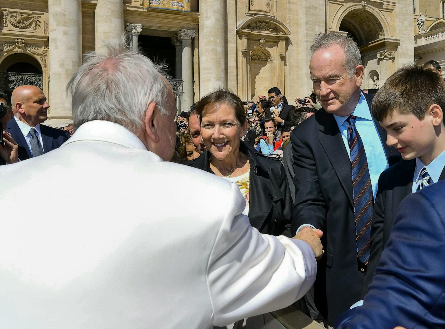 Pope Francis shakes hands with TV host Bill O'Reilly, second from right, during his weekly general audience, at the Vatican, Wednesday, April 19, 2017. O'Reilly is on a two-week vacation that on Wednesday took him to Francis� general audience in St. Peter�s Square. (L'Osservatore Romano/Pool Photo via AP)