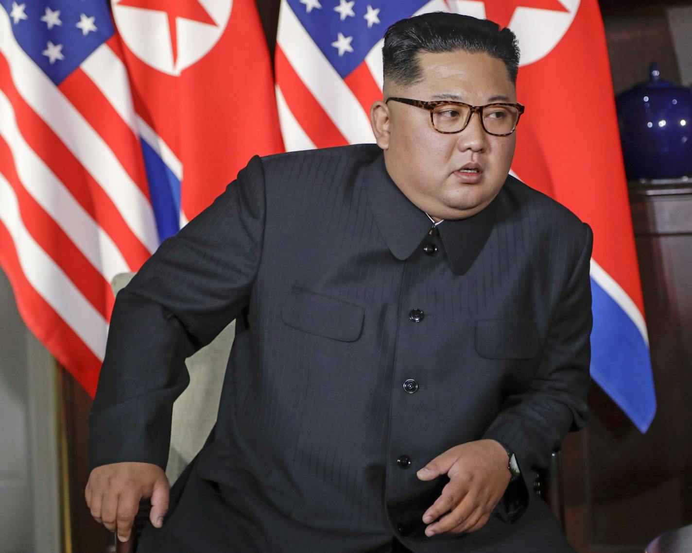 North Korea leader Kim Jong Un leans in to listen to U.S. President Donald Trump during their first meeting at the Capella resort on Sentosa Island Tuesday, June 12, 2018 in Singapore.