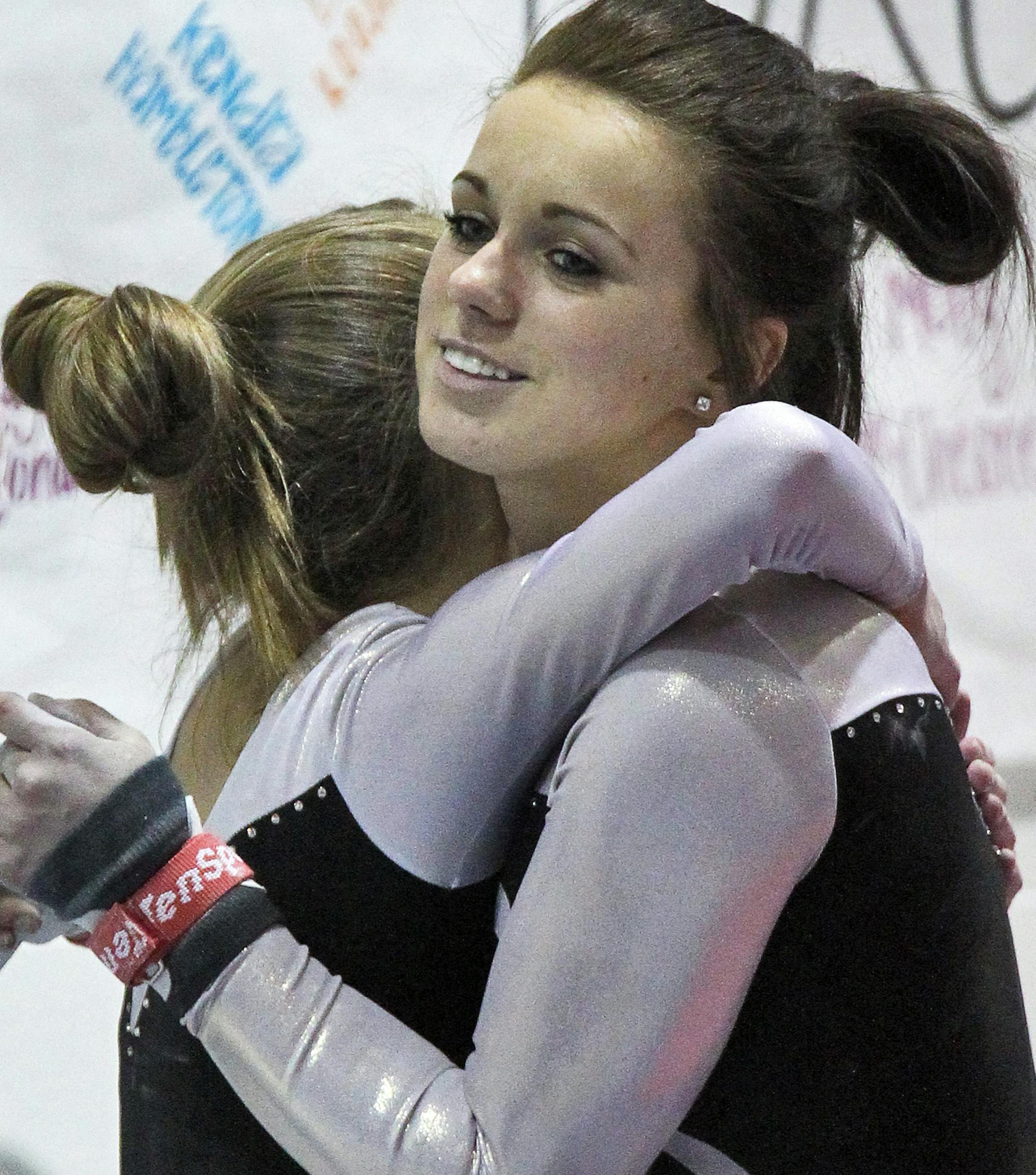 Kaylee Jondahl is having a successful year as an Elk River High School gymnast. Jondahl, right, was congratulated by a teammate after a successful performance on the uneven bars. (MARLIN LEVISON/STARTRIBUNE(mlevison@startribune.com (cq - ) ORG XMIT: MIN1301251004590649
