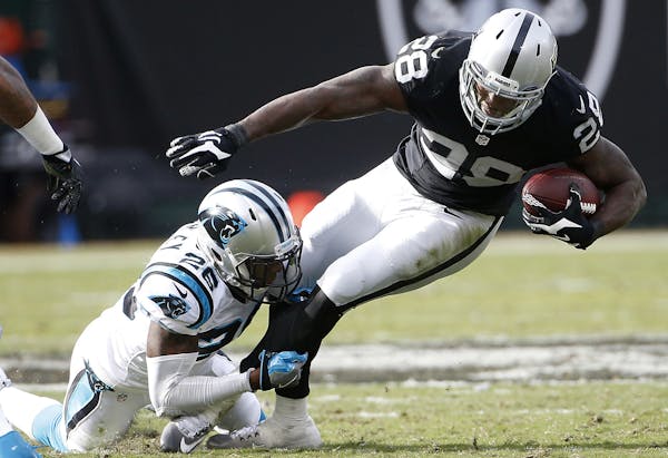 Carolina Panthers cornerback Daryl Worley (26) tackles Oakland Raiders running back Latavius Murray (28) during the first half of an NFL football game