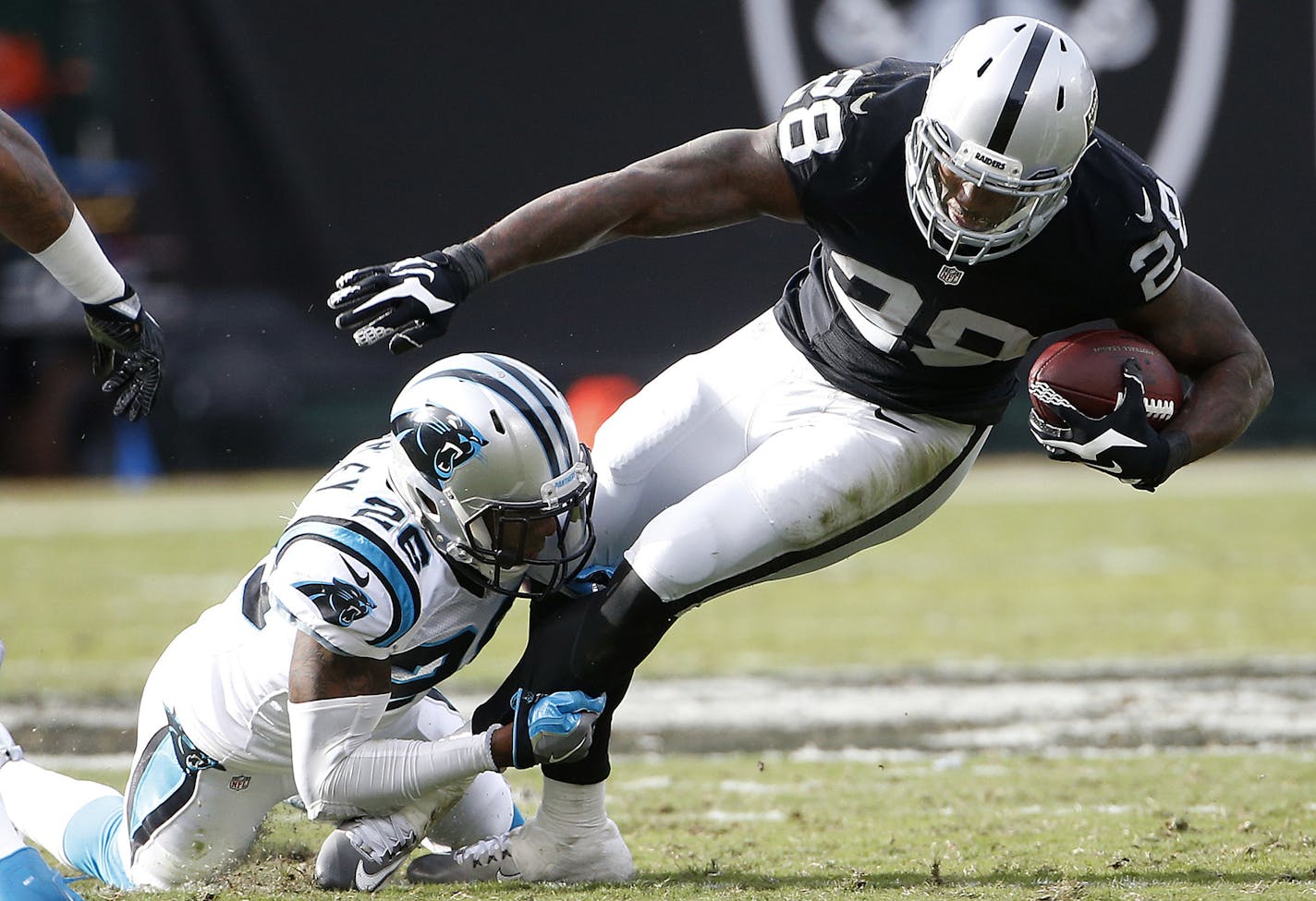 Carolina Panthers cornerback Daryl Worley (26) tackles Oakland Raiders running back Latavius Murray (28) during the first half of an NFL football game in Oakland, Calif., Sunday, Nov. 27, 2016. (AP Photo/Tony Avelar) ORG XMIT: OAS