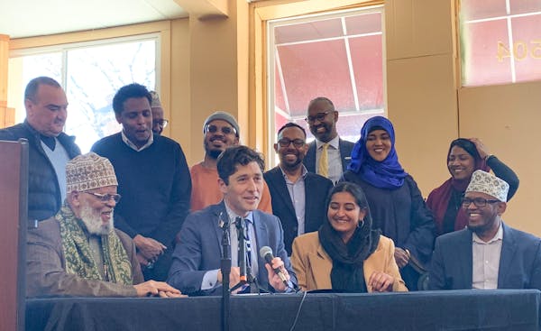 Minneapolis Mayor Jacob Frey, surrounded by Muslim leaders, speaks Monday after signing a change in the city’s noise regulations to allow the Muslim