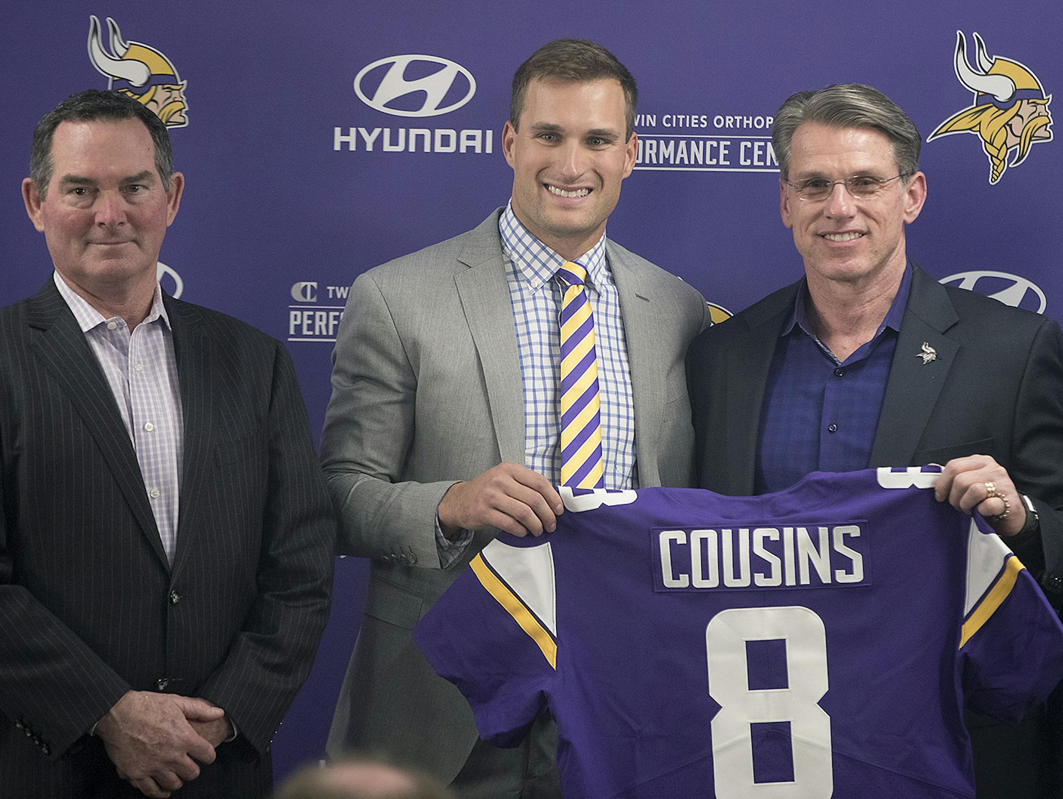 Minnesota Vikings Head Coach Mike Zimmer, left, stood next to Kirk Cousins, along with general manager Rick Spielman and co-owner Mark Wilf as he officially became a Vikings quarterback during a press conference at the Vikings TCO Performance Center, Thursday, March 15, 2018 in Eagan, MN. ] ELIZABETH FLORES ï liz.flores@startribune.com