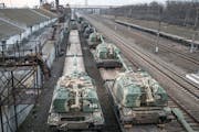 Russian howitzers are loaded onto train cars at a station outside Taganrog, Russia, near the border with Ukraine, on Tuesday, Feb. 22, 2022. 