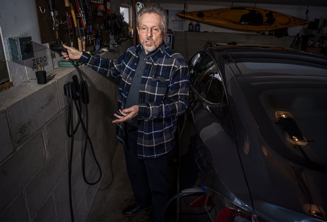 Rep. Steve Elkins, DFL-Bloomington, demonstrates charging his Tesla in his garage in February 2022.