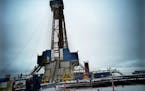 A rig was drilling three new wells in North Dakota in this file photo.