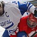 Outdoor games at TCF Bank Stadium on Saturday -- as shown by Benilde-St. Margaret's Auggie Moore (right) battling Minnetonka's AJ Klein for the puck -