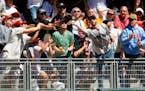 Fans reach for the home run ball hit by Minnesota Twins' Ryan Jeffers against the Boston Red Sox in the third inning of a baseball game Sunday, May 5,