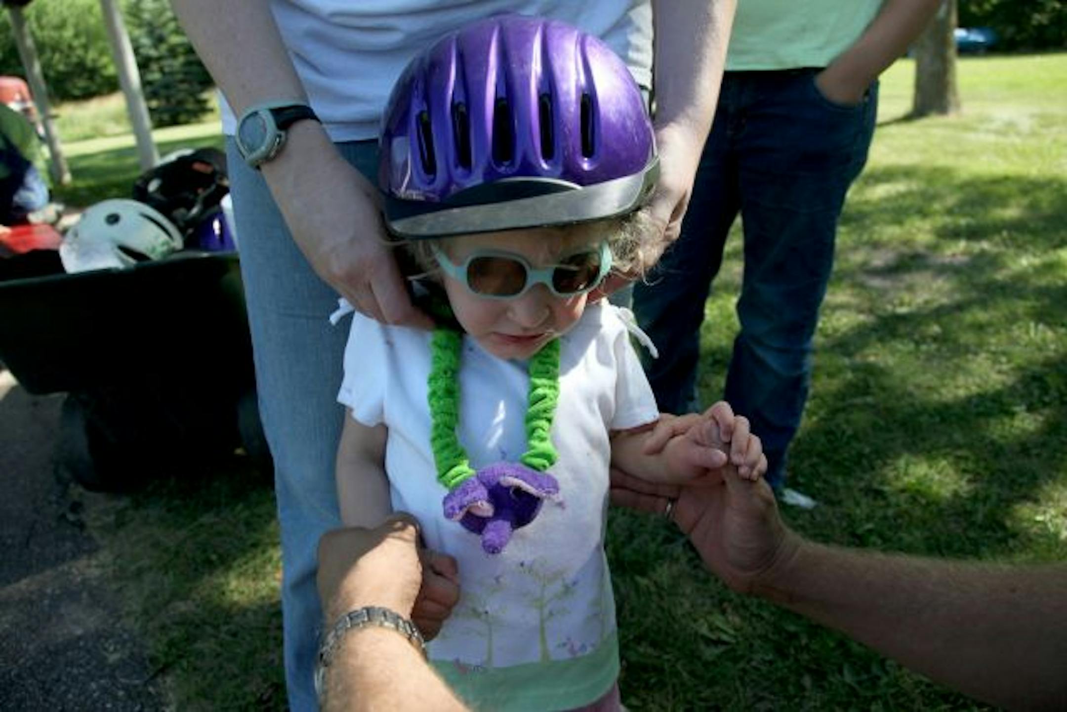 Jason Laumb helped daughter Eleanor, 3, gear up to ride a horse at Camp Courage. Eleanor has a genetic disorder called 10q26 deletion.